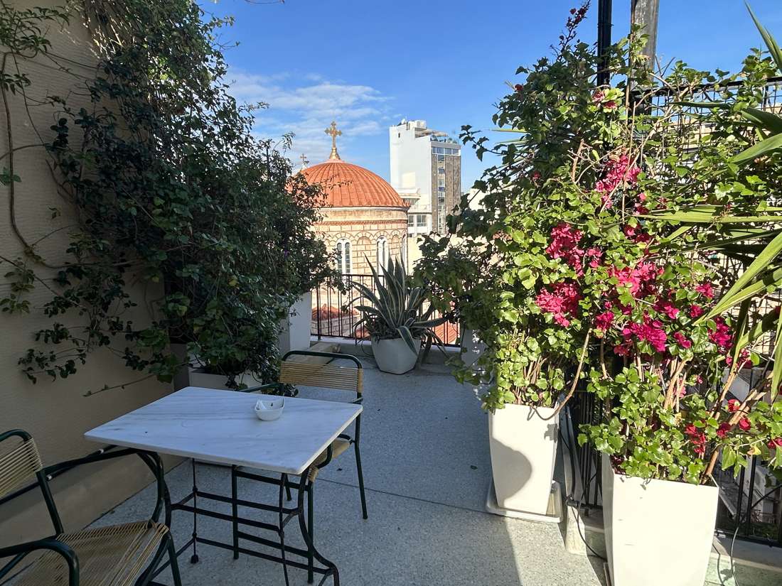Veranda table and chairs with a view of the church dome, Monastiraki, Athens